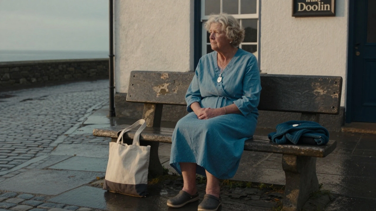 Elderly woman in vintage cotton dress sitting on a stone bench beside a Doolin pub